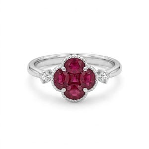 May include: A silver-toned ring featuring a central cluster of four oval-cut deep red rubies arranged in a clover-like pattern. The setting is accented with a small round-cut clear gemstone on each side of the band, finished with milgrain detailing.