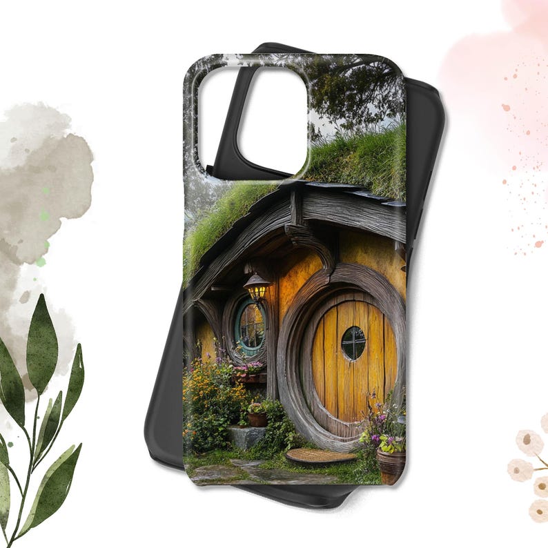 May include: A black phone case with a colorful image of a hobbit house with a round wooden door and a green roof. The house is surrounded by lush greenery and flowers.