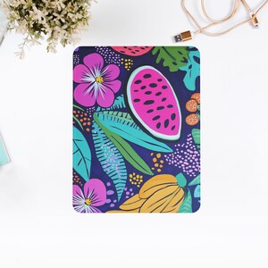 May include: A colorful phone case with a tropical design featuring pink flowers, green leaves, yellow bananas, and a watermelon on a dark blue background.