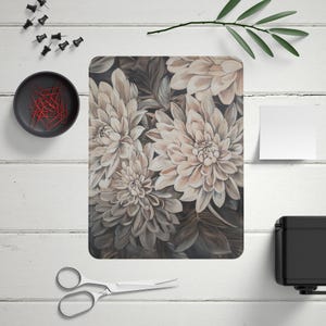 May include: A close-up of a floral print with beige and brown flowers on a dark background. The flowers are in full bloom and have a soft, delicate texture.