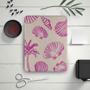 May include: A pink and white fabric mouse pad with a tropical palm tree and seashells design.
