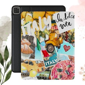 May include: A colorful collage of Italian imagery on a black and white iPad case. The case features a Vespa scooter, pizza, lemons, croissants, and the text "la dolce vita" and "Italy".