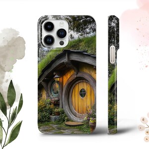May include: A phone case with a green, brown, and yellow hobbit house with a round door and a window. The house is surrounded by green grass and flowers.