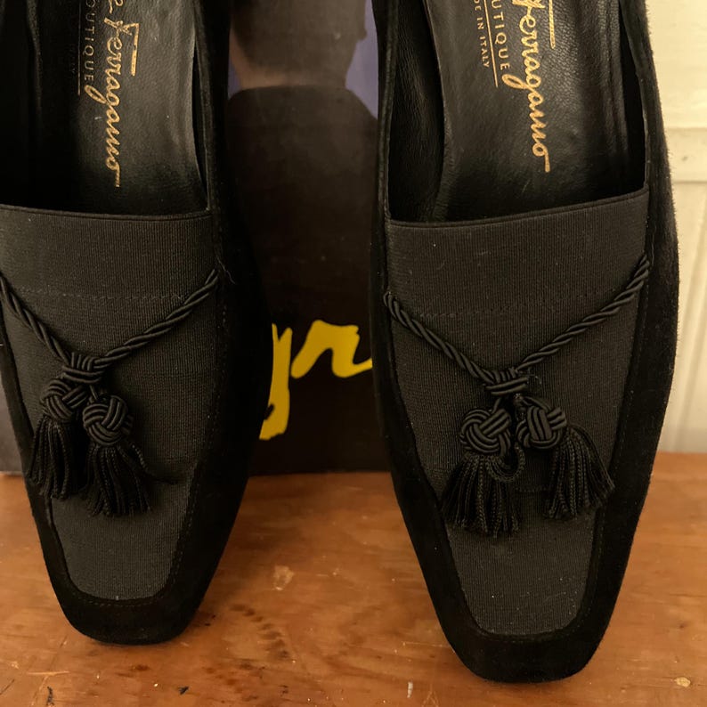 Vintage Salvatore Ferragamo Boutique Black Suede Loafer Pumps | 90s Square Toe Block Heel | Braided Rope Tassel Shoes | Size 8 
Made in Italy

A gorgeous pair of Salvatore Ferragamo Boutique loafers!  Deep saturated black suede (nubuck) finish and a distinctive braided rope tassel detail on top of black elastic vamp. Sophisticated tassel detail and streamlined silhouette, blocked heel and iconic square toe. Genuine Suede Upper, Leather
Made in Italy In Excellent Vintage Condition.