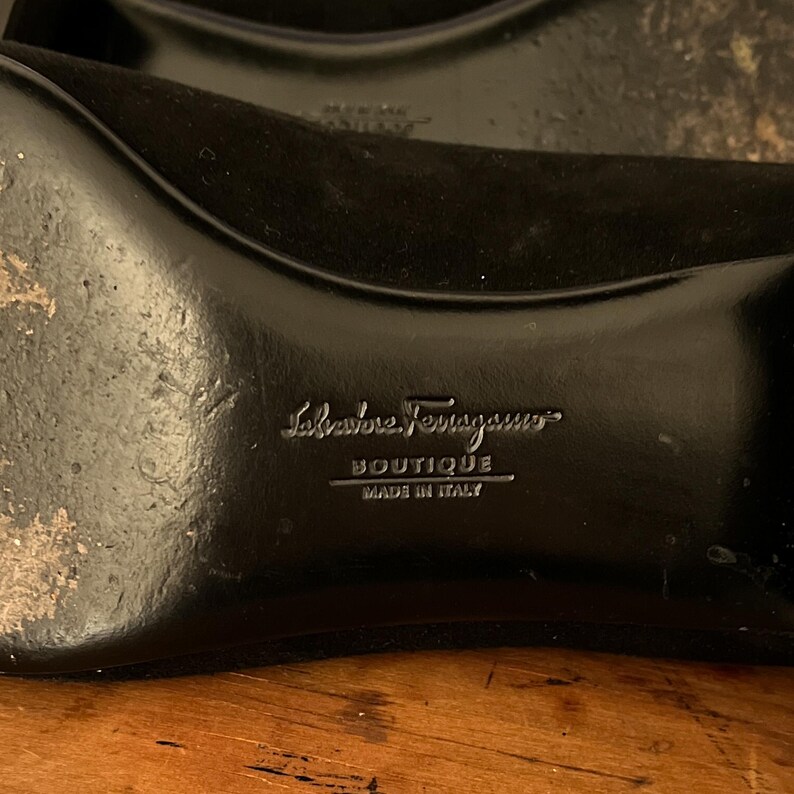 Vintage Salvatore Ferragamo Boutique Black Suede Loafer Pumps | 90s Square Toe Block Heel | Braided Rope Tassel Shoes | Size 8 
Made in Italy

A gorgeous pair of Salvatore Ferragamo Boutique loafers!  Deep saturated black suede (nubuck) finish and a distinctive braided rope tassel detail on top of black elastic vamp. Sophisticated tassel detail and streamlined silhouette, blocked heel and iconic square toe. Genuine Suede Upper, Leather
Made in Italy In Excellent Vintage Condition.