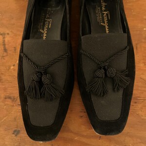 Vintage Salvatore Ferragamo Boutique Black Suede Loafer Pumps | 90s Square Toe Block Heel | Braided Rope Tassel Shoes | Size 8 
Made in Italy

A gorgeous pair of Salvatore Ferragamo Boutique loafers!  Deep saturated black suede (nubuck) finish and a distinctive braided rope tassel detail on top of black elastic vamp. Sophisticated tassel detail and streamlined silhouette, blocked heel and iconic square toe. Genuine Suede Upper, Leather
Made in Italy In Excellent Vintage Condition.