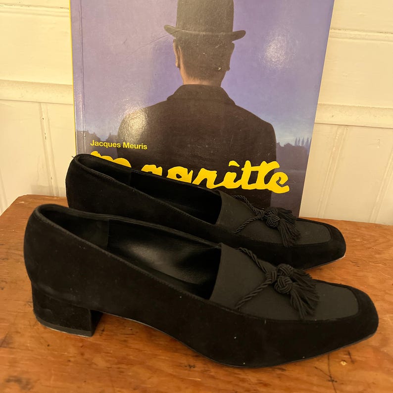 Vintage Salvatore Ferragamo Boutique Black Suede Loafer Pumps | 90s Square Toe Block Heel | Braided Rope Tassel Shoes | Size 8 
Made in Italy

A gorgeous pair of Salvatore Ferragamo Boutique loafers!  Deep saturated black suede (nubuck) finish and a distinctive braided rope tassel detail on top of black elastic vamp. Sophisticated tassel detail and streamlined silhouette, blocked heel and iconic square toe. Genuine Suede Upper, Leather
Made in Italy In Excellent Vintage Condition.