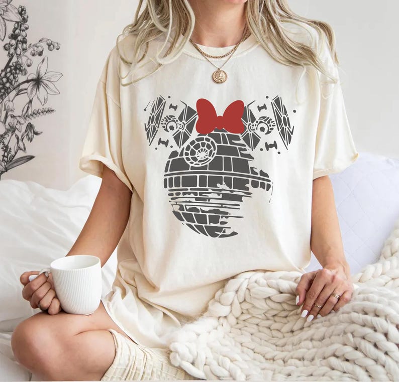a woman sitting on a bed holding a cup of coffee