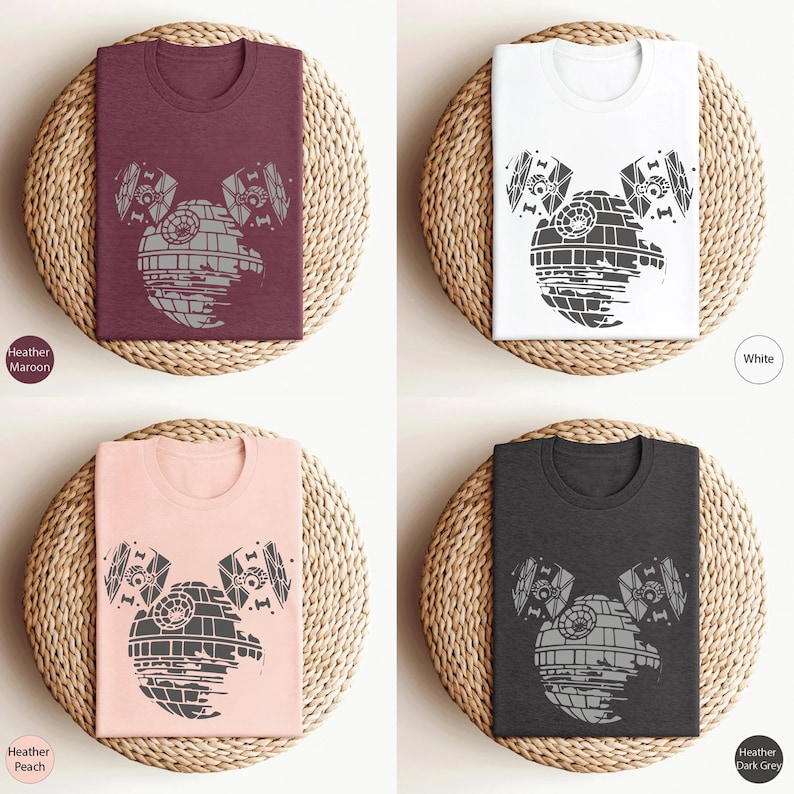 May include: Four t-shirts with a graphic of the Death Star from Star Wars, designed to look like Mickey Mouse ears. The t-shirts are available in Heather Maroon, Heather Peach, White, and Heather Dark Grey.