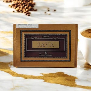 May include: A wooden box with a brown label that reads "Premium Hand Made Long Filler JAVA by Drew Estate".
