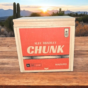 May include: A wooden box with a red label that says "Alec Bradley Chunk Maduro" in white lettering. The box is labeled "XL Large" and "4 x 60".