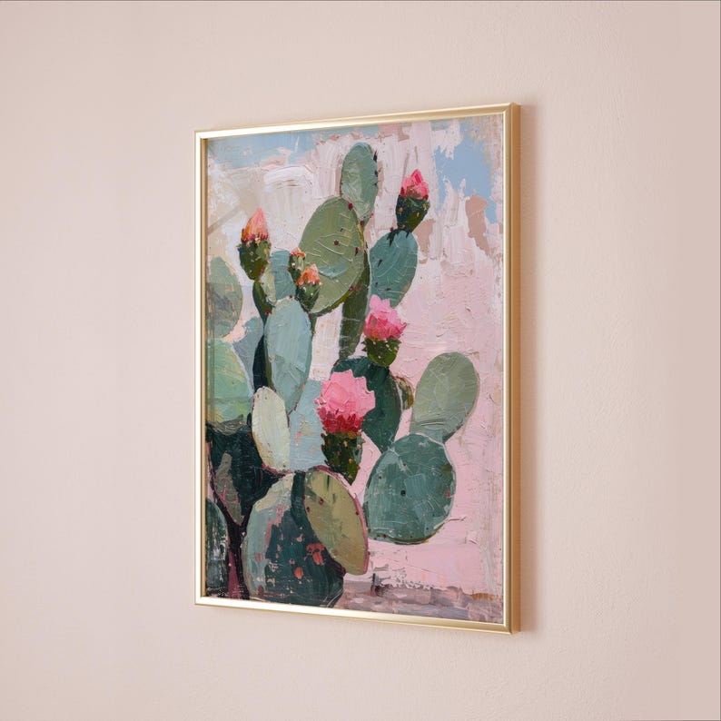 May include: A framed painting of a cactus with pink flowers. The cactus is green and has a textured surface. The background is a light pink color.