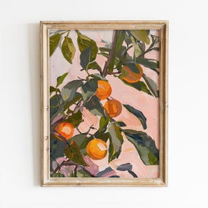 May include: A framed painting depicting a branch of a citrus tree with orange fruit against a pink background. The leaves are green and the fruit is a vibrant orange.