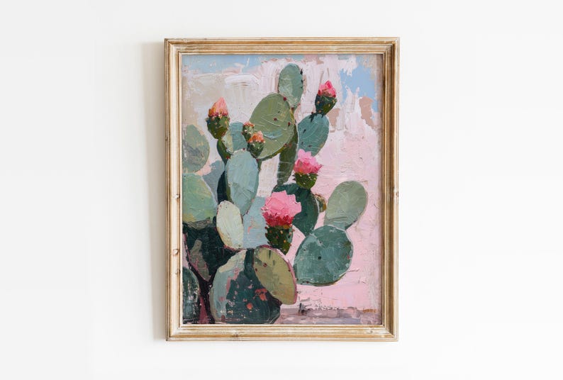 May include: A framed painting of a cactus with pink flowers against a pink and white background.