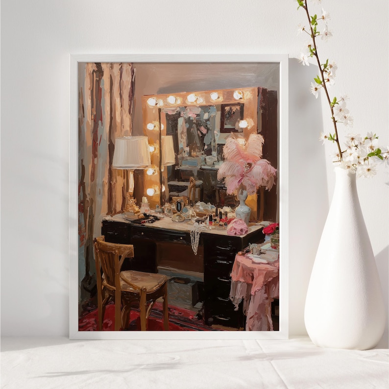 May include: A framed painting depicts a vintage vanity scene. The black vanity is adorned with makeup, jewelry, and a lamp. A large mirror with lights is above the vanity. A vase with flowers is on the right.