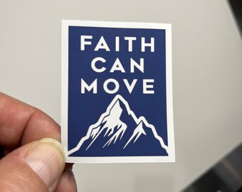 May include: A blue sticker with white text that reads "FAITH CAN MOVE" and a white mountain silhouette.