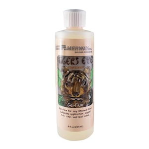 May include: A bottle of "Tiger's Eye" Gel-Flux for stained glass soldering. The label features a tiger illustration and the text "MERWAY Solder Products." The bottle contains 237 ml of flux.