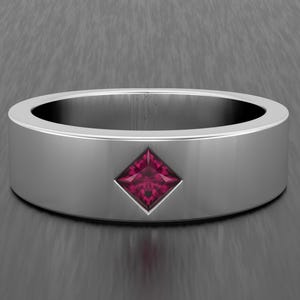 May include: A silver ring with a square, deep red gemstone set in the center. The ring has a flat, wide band and a polished finish, showcasing a minimalist design. The gemstone is a vibrant, eye-catching focal point.