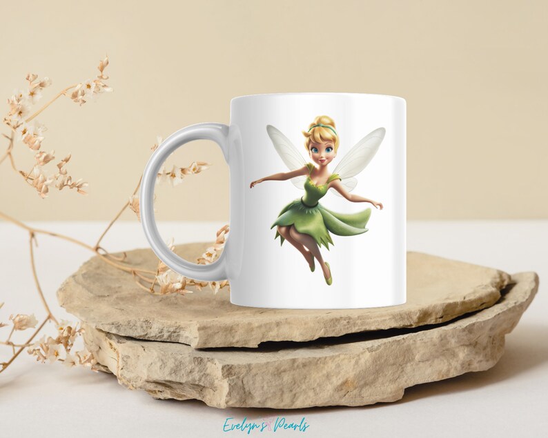 May include: White ceramic mug with a colorful illustration of Tinkerbell, a fairy with green wings and a green dress, flying.