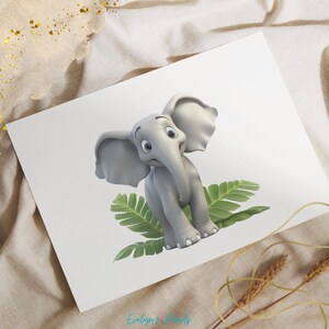May include: A print featuring a cartoon elephant in shades of gray, sitting on green leaves. The elephant has large ears and a trunk. The print is on a white background, with the text "Evelyn's Woods" in the bottom right corner.