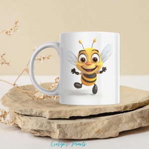 May include: White ceramic mug with a cartoon bee design. The bee is yellow and black with a smiling face and outstretched arms.