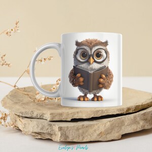 May include: White ceramic mug with a brown owl wearing glasses and holding a book. The owl is looking at the book.