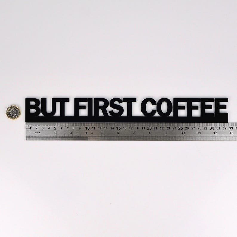 BUT FIRST COFFEE door topper shown with ruler and pound coin for accurate size reference.