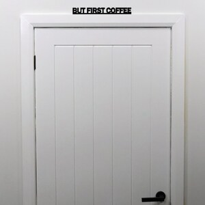 BUT FIRST COFFEE door topper mounted above a white interior kitchen door.
