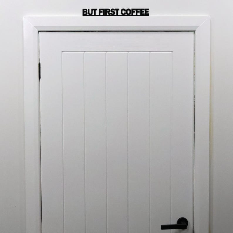 BUT FIRST COFFEE door topper mounted above a white interior kitchen door.