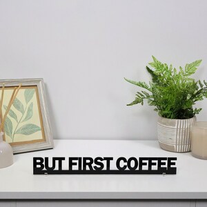 Black acrylic BUT FIRST COFFEE sign displayed alongside coffee station decor, adding personality and style to kitchens, breakfast areas and home coffee bars.