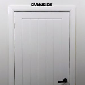 Black acrylic over door sign installed above a standard interior door, suitable for offices, bedrooms and creative spaces.