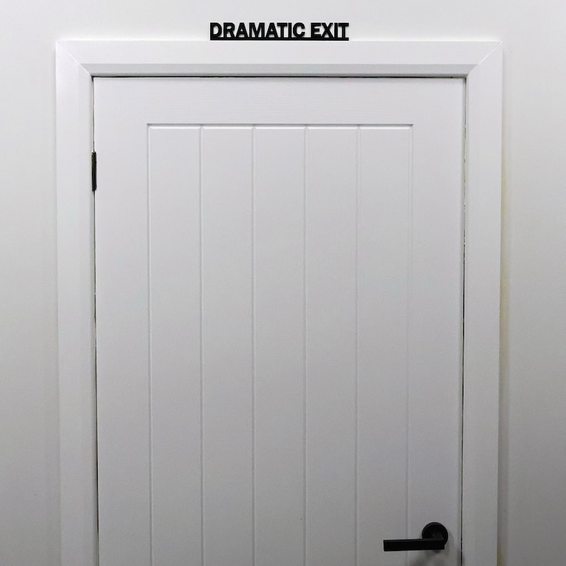 Black acrylic over door sign installed above a standard interior door, suitable for offices, bedrooms and creative spaces.