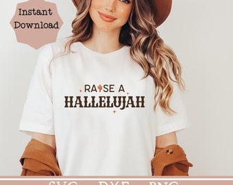 May include: White t-shirt with brown text that reads "Raise a Hallelujah" with a small cactus graphic. The text is in a vintage style font.