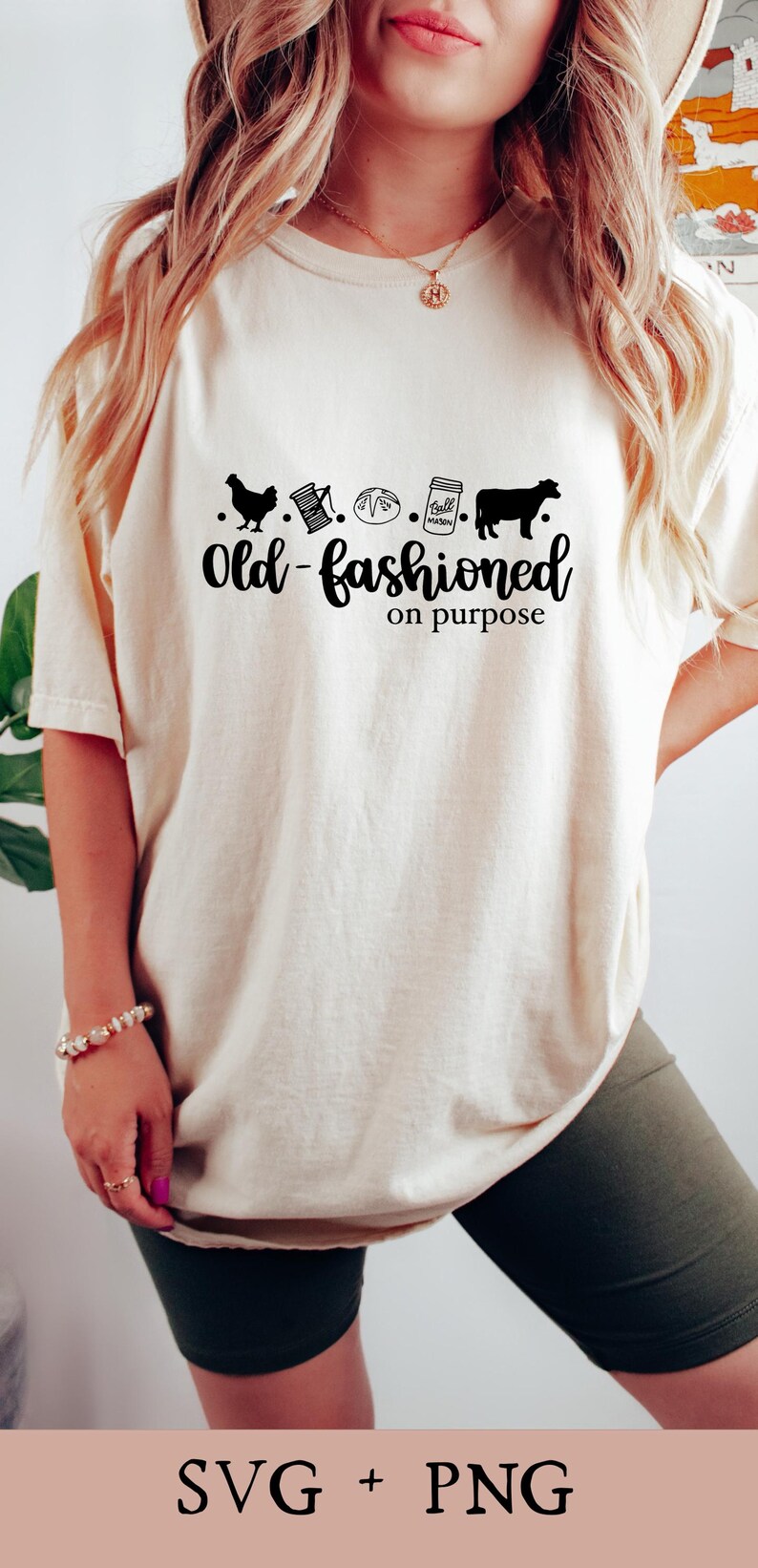 May include: A white t-shirt with a black graphic design that says "Old-fashioned on purpose". The graphic includes a chicken, a spool of thread, a loaf of bread, a mason jar, and a cow.