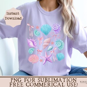 May include: A purple t-shirt with a design of seashells, starfish, and pearls. The design is in shades of pink, blue, and white. The text "Instant Download" and "PNG for Sublimation Free Commercial Use!" is on the shirt.