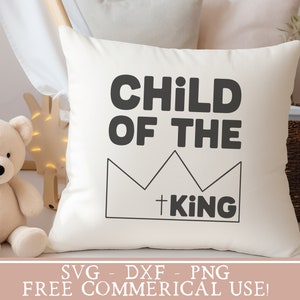 May include: White pillow with black text that reads "Child of the King" with a crown graphic.  The text is in a bold, blocky font.  The pillow is on a white surface.