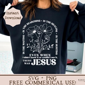 May include: A black sweatshirt with a white graphic design featuring a floral motif and the text "In the waiting, in the searching, in the healing, in the hurting. Even when I didn't know it or couldn't see it, there was Jesus."