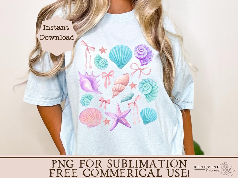 May include: A light blue t-shirt with a design of pastel pink, blue, and purple seashells, starfish, and bows. The design is centered on the shirt.