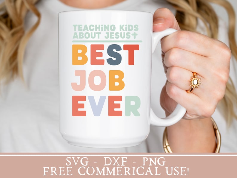 May include: White ceramic mug with the text "TEACHING KIDS ABOUT JESUS+ BEST JOB EVER" in colorful letters. The mug is being held by a person's hand. The text "SVG - DXF - PNG FREE COMMERICAL USE!" is at the bottom of the image.