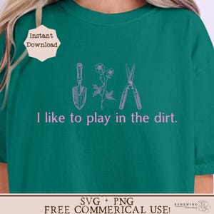 May include: A green t-shirt with the text "I like to play in the dirt." in pink. The text is surrounded by a trowel, a flower, and a pair of pruning shears, all in pink.