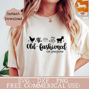 May include: A white t-shirt with a black graphic design that says "Old-fashioned on purpose". The graphic includes a chicken, a spool of thread, a loaf of bread, a mason jar, and a goat. The text "SVG - DXF - PNG FREE COMMERCIAL USE!" is at the bottom of the image.