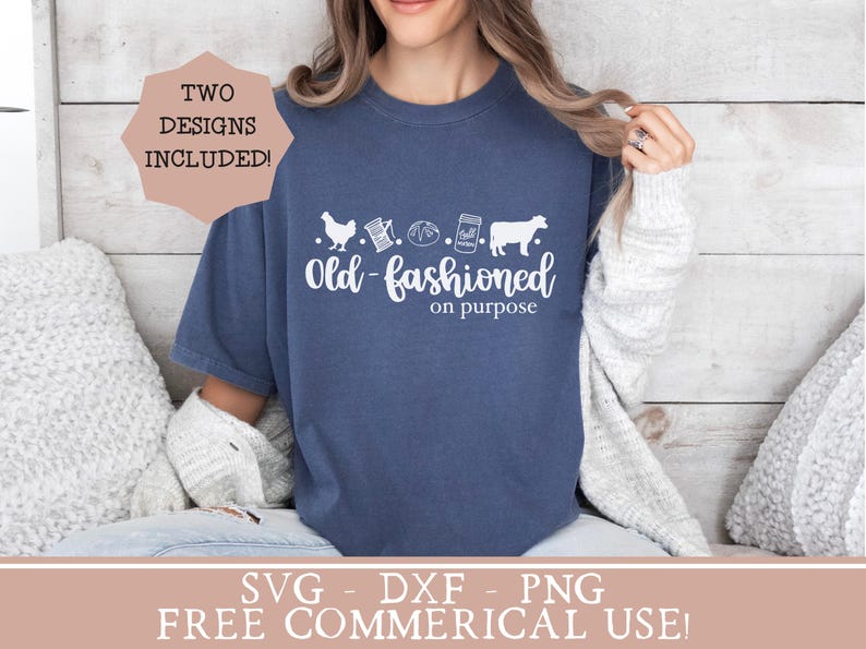 May include: A woman wearing a blue t-shirt with the text "Old-fashioned on purpose" and a design of a chicken, a spool of thread, a loaf of bread, a jar of jam, and a cow. The text "Two Designs Included!" is in a pink circle in the top left corner of the image.