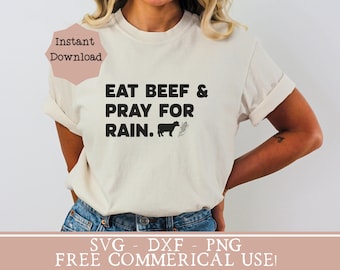 May include: A white t-shirt with the text "EAT BEEF & PRAY FOR RAIN." in black lettering. A black silhouette of a cow and a corn stalk are next to the text. The text "Instant Download" is in a pink box in the top left corner. The text "SVG - DXF - PNG FREE COMMERCIAL USE!" is in a pink box at the bottom of the image.