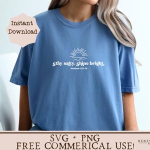 May include: A blue t-shirt with the text "Stay salty. Shine bright." and a sun graphic. The text "Matthew 5:13-16" is below the main text. The shirt is a casual wear item.
