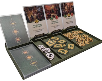 May include: A green game organizer with four card slots and multiple compartments for game pieces. The organizer has a card slot for a card with the text "Dew Collectors for the Planting" and another card slot for a card with the text "The Fremen Call Paul the Mand".
