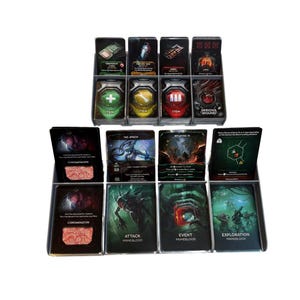 May include: A collection of game cards, organized in black plastic trays. The cards feature various illustrations and text, including "TERMINATION CORPS," "ITEM," and "EXPLORATION PRIMEBLOOD." The color palette includes green, red, yellow, and black.