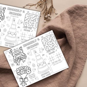May include: Two black and white wedding activity sheets with the names "Kimberly & Richard" and the date. Each sheet features a maze, tic-tac-toe, a wedding cake, and a car with a "Just Married" sign.