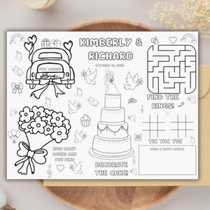 May include: Black and white wedding activity sheet with a car, flowers, cake, and maze. Text includes "Kimberly & Richard", "Find the Rings!", "Decorate the Cake!", and "Tic Tac Toe".