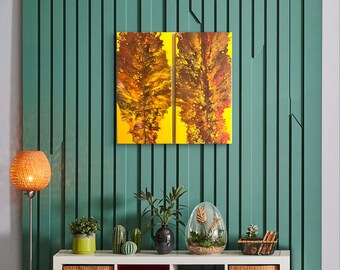 May include: Abstract painting on canvas with two panels, featuring a yellow and brown color scheme. The painting is hanging on a teal wall.