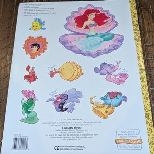 May include: Back cover of a Golden Book featuring Disney's The Little Mermaid. The cover displays Ariel in a seashell, along with other characters like Flounder and Sebastian. The book is from 1997.